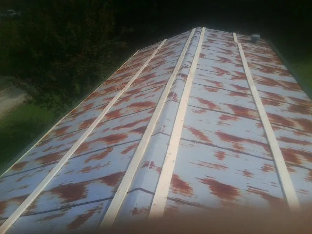 Rusted metal roof panels with new wood purlins before replacement — Storm Damage Roof Repair in Cedarburg by Roofing Brothers