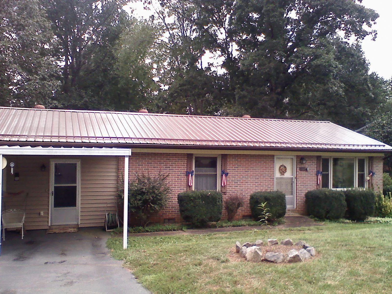 Bronze metal roof and carport on a brick ranch home — Roof Repair work by our crew in Cedarburg